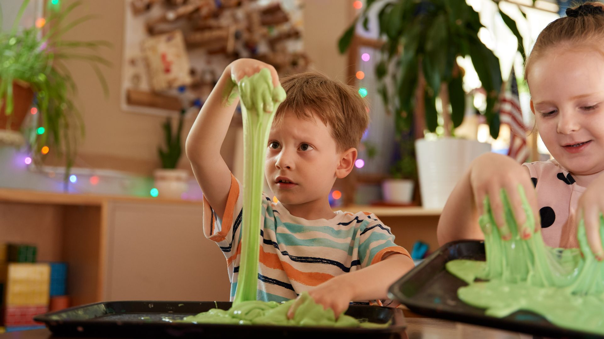 photo of boy playing with slime